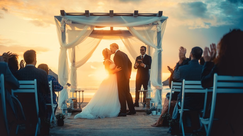 couple kissing at wedding ceremony