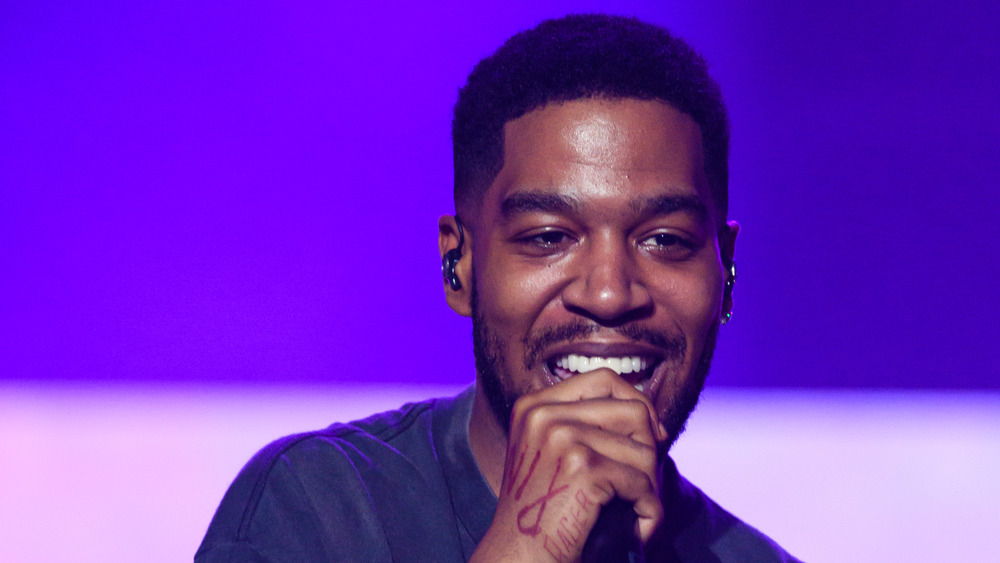 Kid Cudi smiling, performing