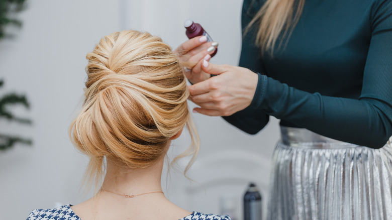 hairstylist doing bridesmaids hair