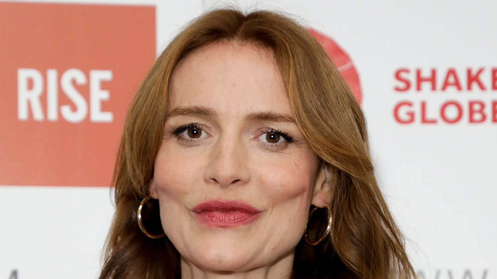 Saffron Burrows wearing hoop earrings