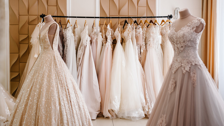 wedding dresses hanging in a bridal store