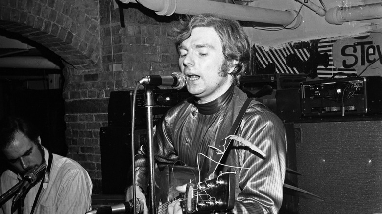 Van Morrison singing, playing guitar