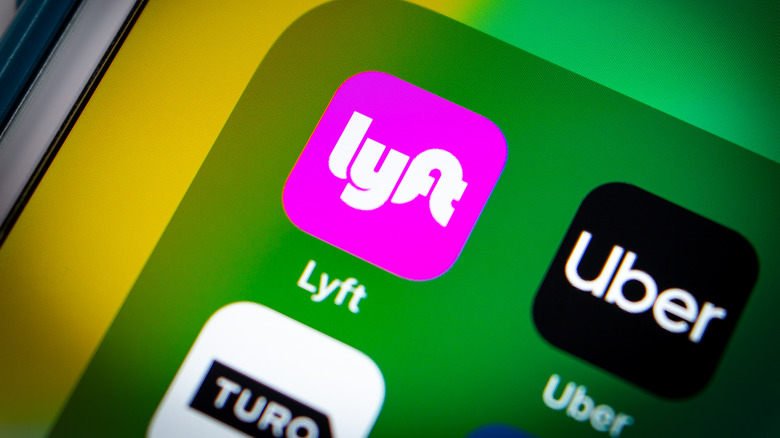 Uber and Lyft apps on cell phone screen