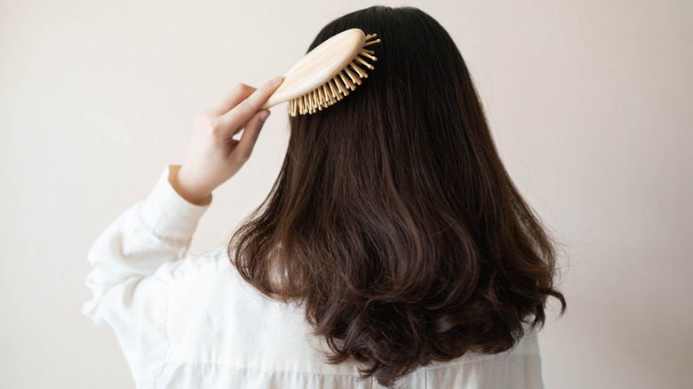 woman brushing her hair