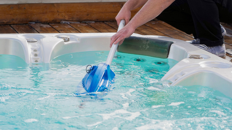 Arms cleaning a hot tub