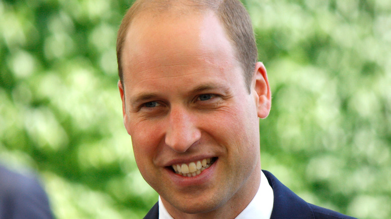 Prince William smiles at an event.