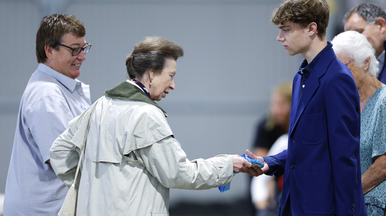 Princess Anne giving medal to teen boy