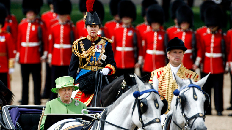 Princess Anne riding a horse during in uniform