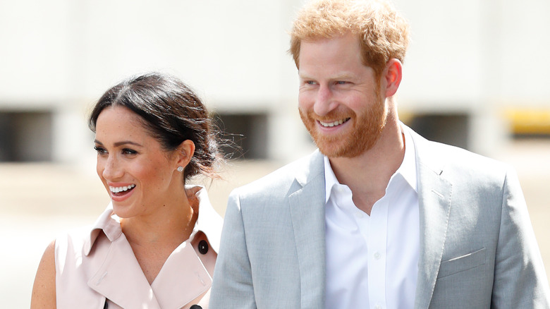 Meghan Markle and Prince Harry smiling at event