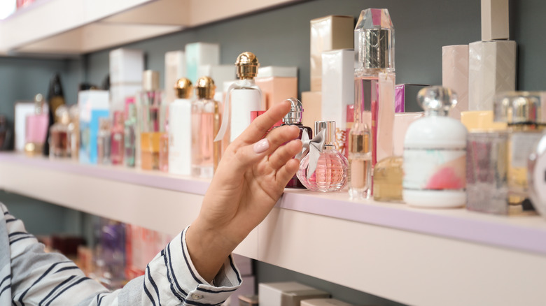 Woman choosing a perfume in the store