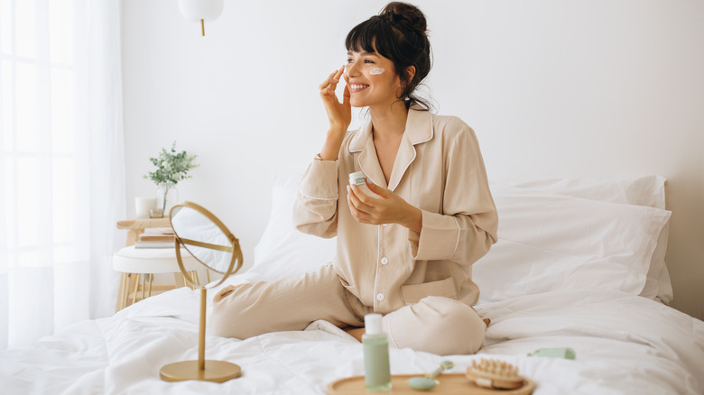 Woman putting on skin cream