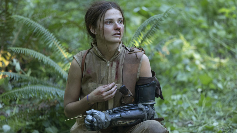 Stefanie Scott as Carrie with a robotic arm in Girl in the Woods