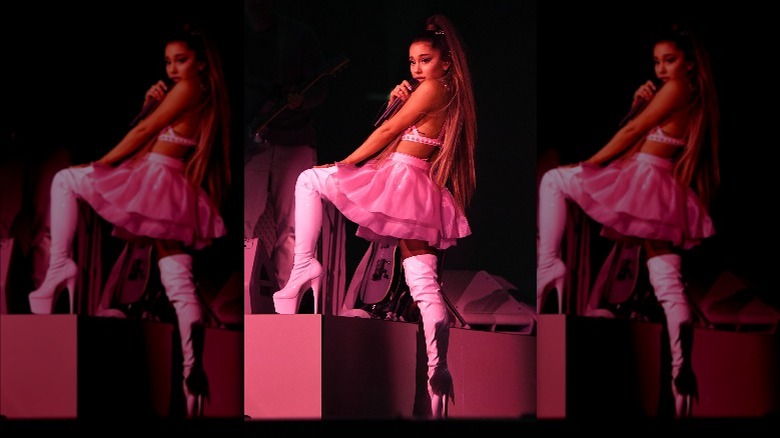 Ariana Grande performing on stage in heeled boots