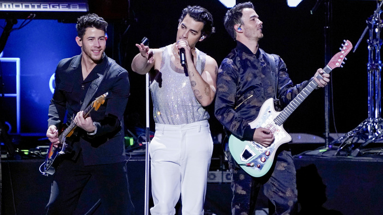 Nick Jonas performing with his brothers