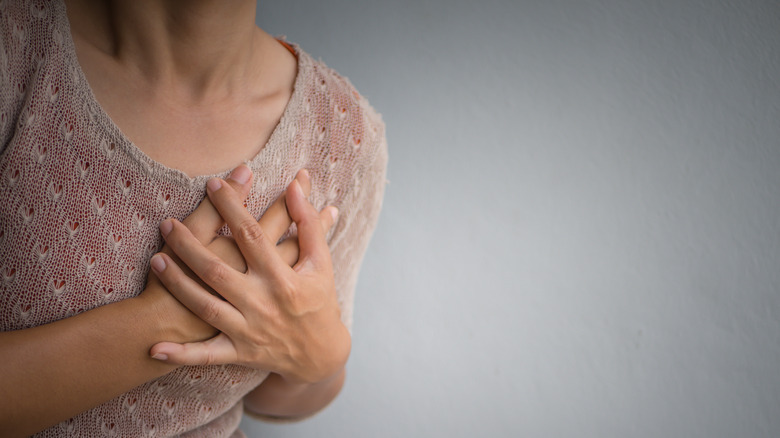 Woman holding her chest