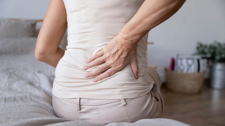 Woman with back pain sitting