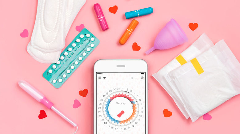 Menstrual cycle items, pink background