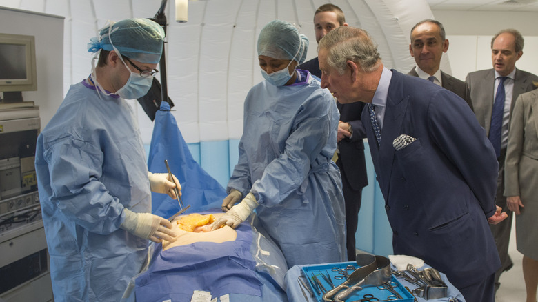 King Charles observing doctors