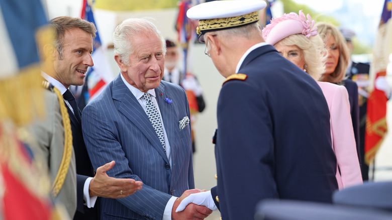 King Charles shaking hands with an official