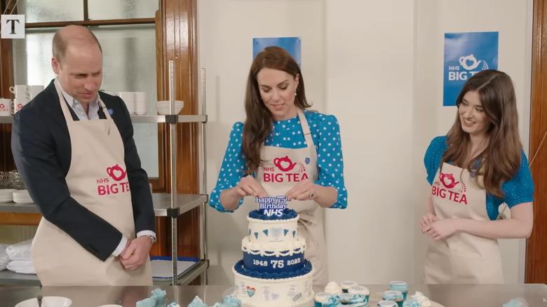 Princess Catherine and Prince William decorating a cake