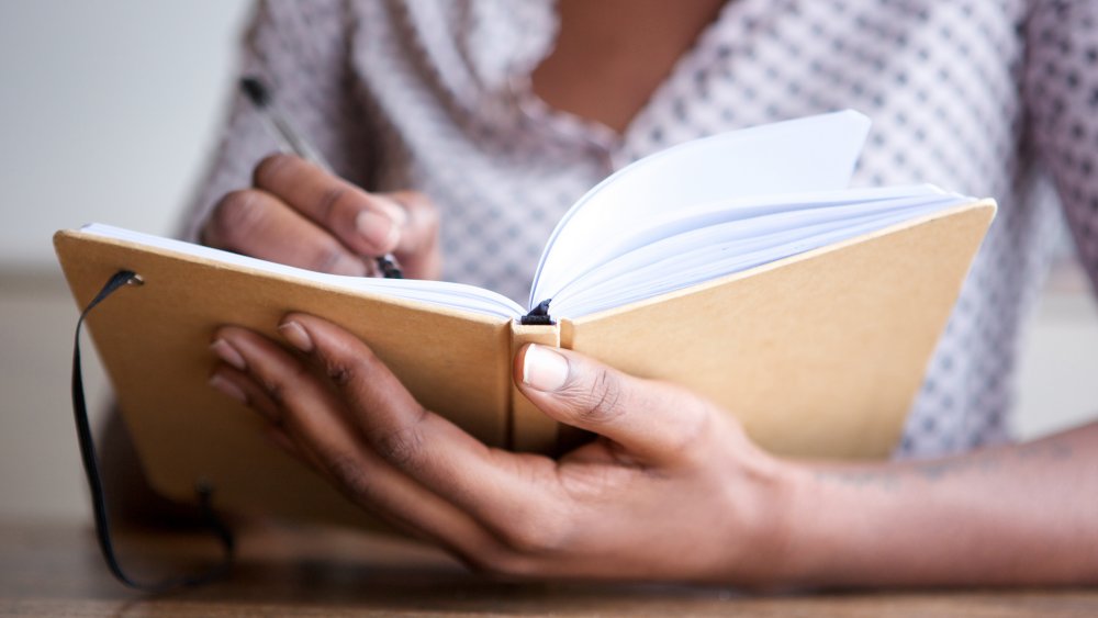 woman writing list of goals