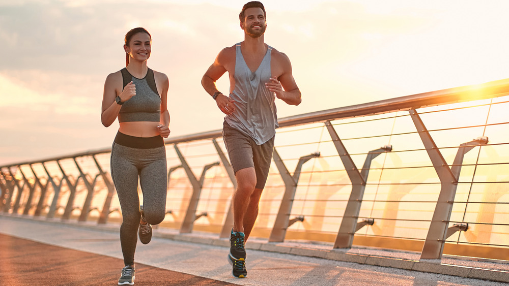 Couple running on bridge