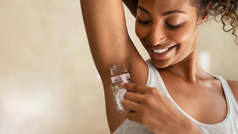 Woman shaving her armpit