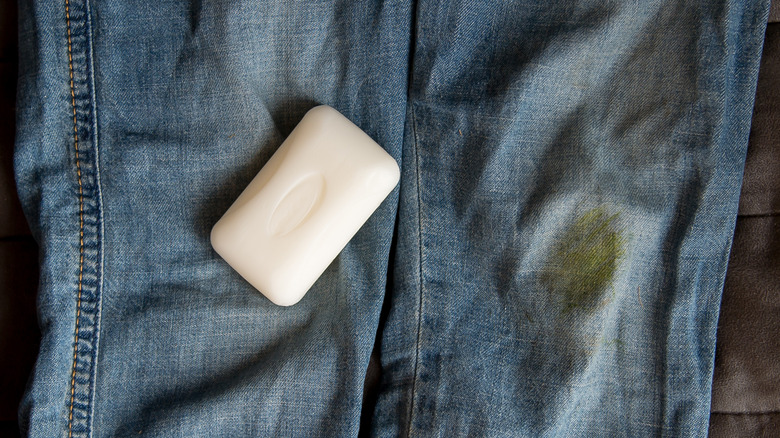 Bar soap next to stained jeans