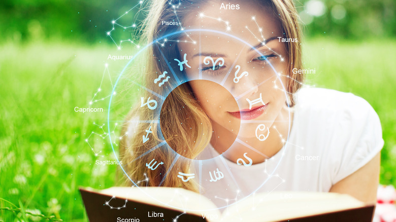 Zodiac sigil over woman reading