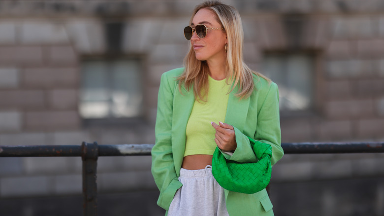 Sonia Lyson wearing green oversized blazer and grey sweatpants