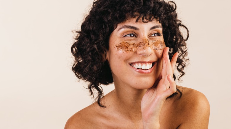 Woman exfoliating under her eyes