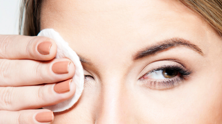 Woman removing her eye makeup