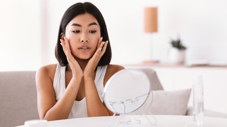 Woman massaging her face