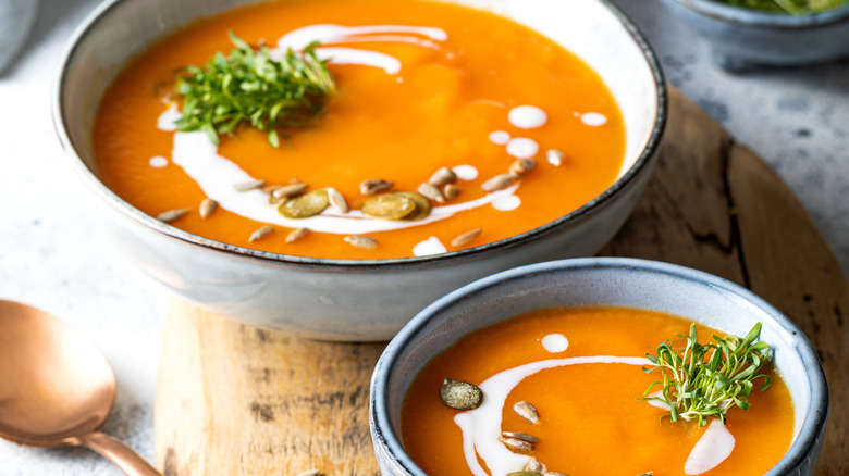 Bowls of pumpkin and carrot soup