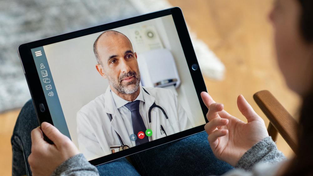 Woman talking to doctor, telehealth