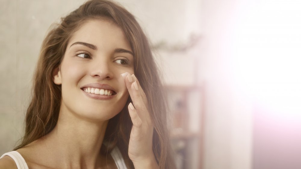 Woman applying makeup