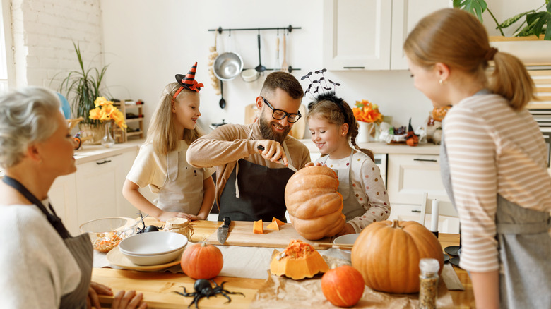 Family cutting pumpkins