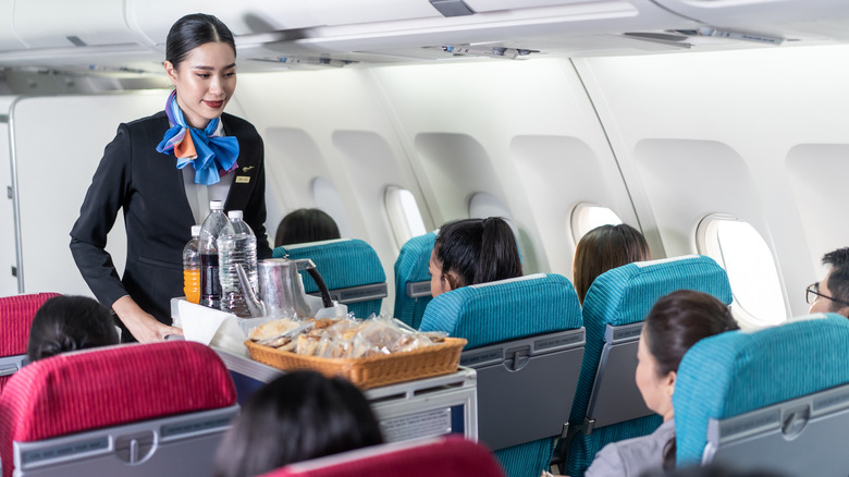 Flight attendant serving food