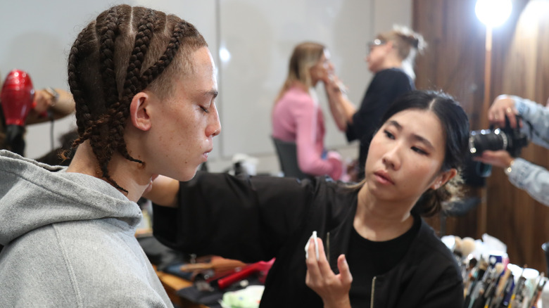 Makeup artist does her client's makeup