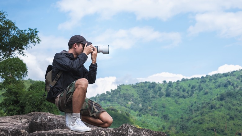 Professional photographer shooting outdoors 