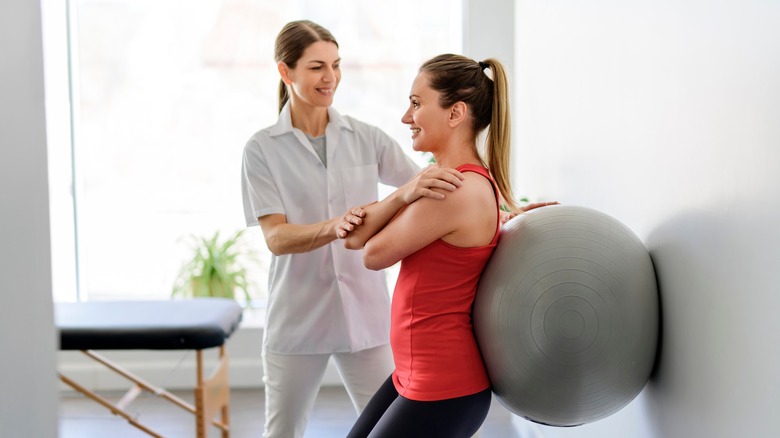 Physical therapist treating patient