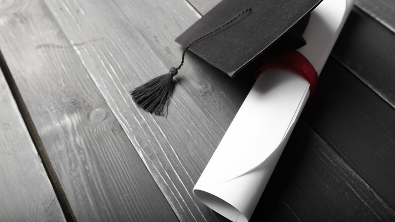 graduation cap and diploma rolled up