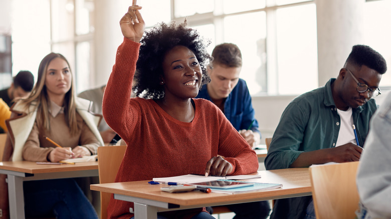 Student raising hand in class