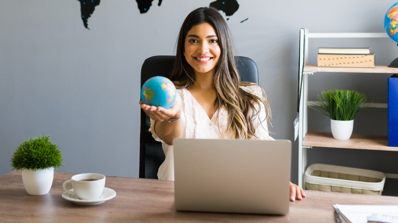 travel agent with globe in hand