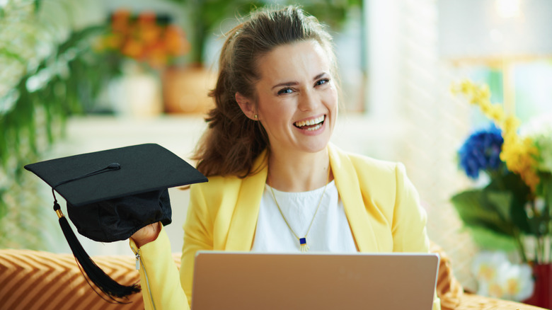 Woman smiling while showing off her graduation cap