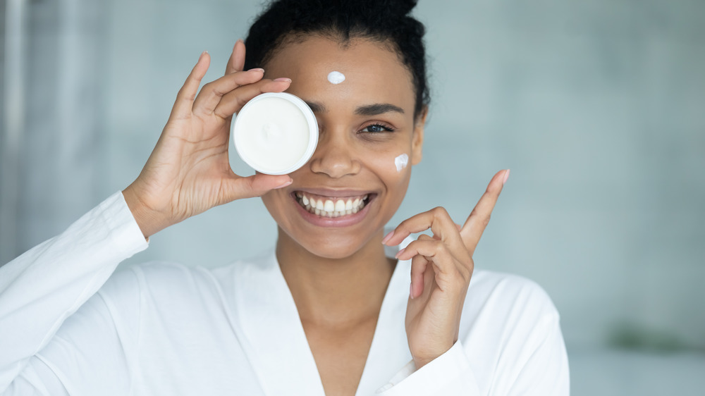 Woman smiling with face cream