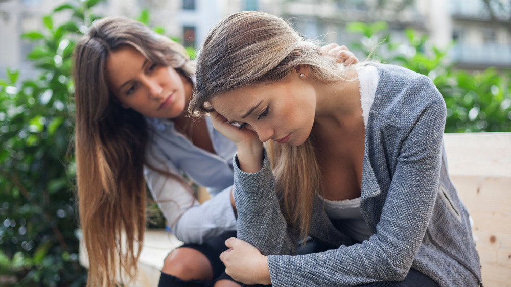 Woman consoling anxious friend