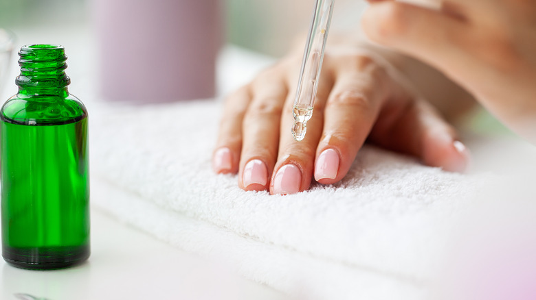 Person applying cuticle oil