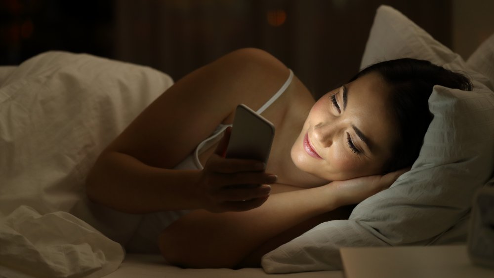 Woman on phone in bed