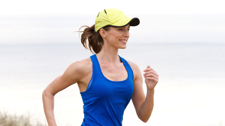 woman running with hat